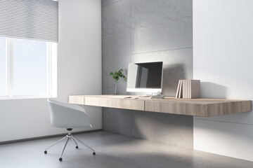 Sunny home office with stylish wooden table without legs, white chair and modern computer monitor