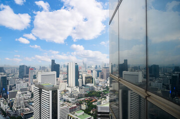Aerial view of Bangkok city with cloud and blue sky in Thailand. cityscape of Modern buildings and urban architecture