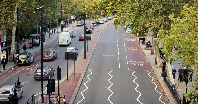 Timelapse of road with cars pedestrians red buses in london shot in 4k