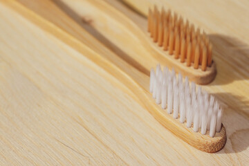 Bamboo plastic free toothbrushes. Wooden background. Zero waste concept. Stock photo with copy space
