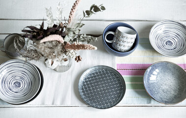 Stylish empty ceramic tableware on the kitchen table top view.