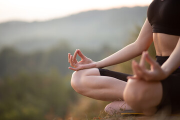 Close up with selective focus of yogi young woman practicing yoga exercises, breathing, meditating, Lotus pose with mudra gesture, working out. Wellbeing, wellness concept