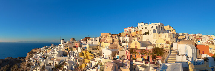 Sunset over Santorini island in Greece. Traditional church, apar