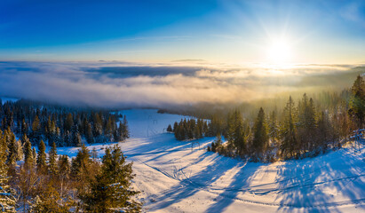Magical winter panorama of beautiful snowy slopes at a ski resort in Europe on a sunny, windless frosty day. The concept of active recreation in winter. Copyspace