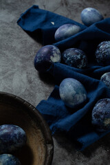 marble eggs on blue towel and old concrete background