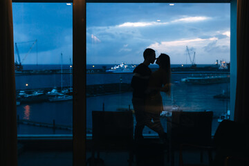 couple on the background of the port hugging and spending time together, travel concept.