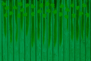 Green holiday st Patricks day tree background or backdrop with blur silhouettes of clover leaves.