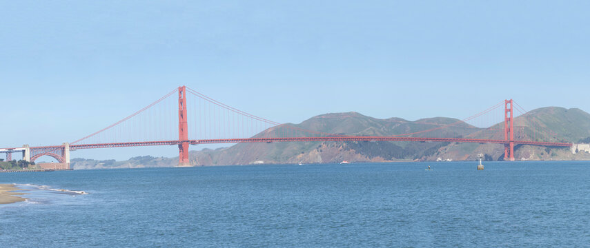 Panoramic of the Golden Gate Bridge, viewed from Little Marina Green, blue sky and Marin hills in background