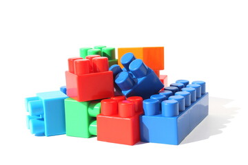 Fototapeta premium Children's bright toys in the form of blocks lie in one heap for construction.