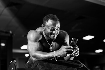Fototapeta na wymiar African American man with a pumped-up body in the gym. Active people sport workout concept