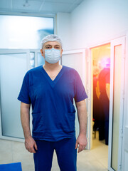 Fototapeta na wymiar Modern medical worker in blue sterile mask. Proffesional doctor posing for camera.