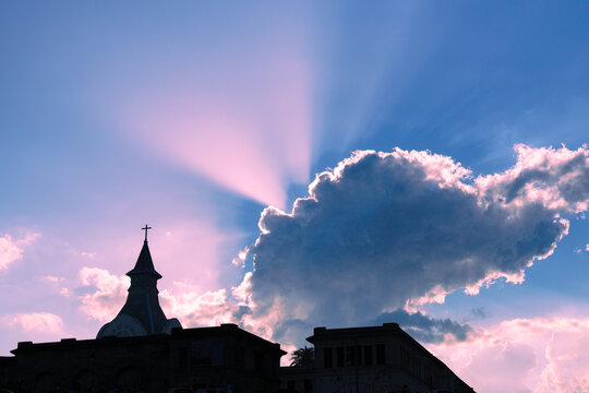 Church silhouette Jesus Christ crucifix on cloudy background sunset with light rays. God, Christian, Holy Spirit themep photo.
