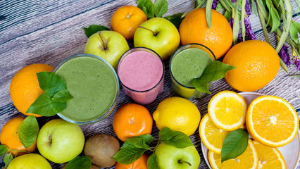 Colorful fresh summer fruits orange apple kiwi grapefruit on brown wooden background, healthy organic food on the table, detox vitamin nutrition for health care, close-up top view