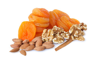 Heap of dried apricots with walnuts, almonds and cinnamon isolated on white