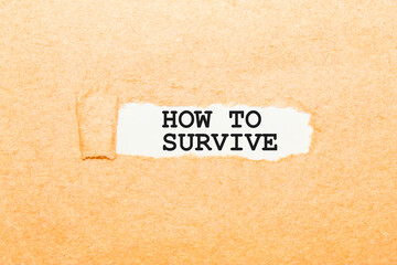 text HOW TO SURVIVE on a torn piece of paper, business concept