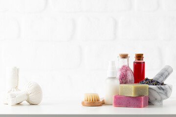 Fototapeta na wymiar Cosmetics bottles and natural handmade soap on white background