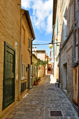 A narrow street between the old buildings of Macerata, a medieval town in the Marche region.