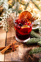 Obraz na płótnie Canvas Christmas mulled wine with spices on a wooden rustic table.