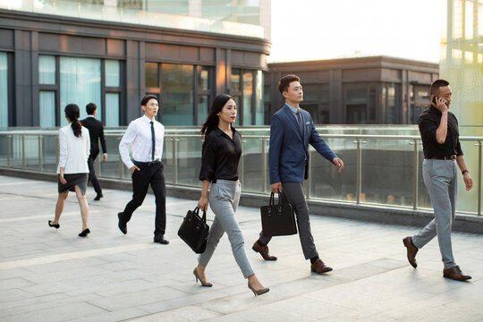 Confident business people walking outdoors