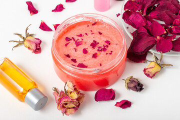 Jar of cosmetic body scrub with rose petals. Natural cosmetic. Home cosmetics