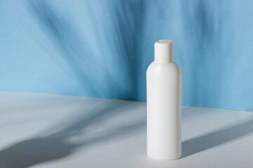 Serum or face cream bottle with shadows on the background. Cosmetic spa product