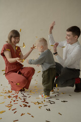 Little boy rejoice at the holiday. The boy has fun and throws some tinsel. Little kid has fun and enjoys the holiday