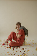 Mom in a red dress is sitting on the floor with her son and having fun. holiday. Body positive