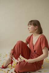Mom in a red dress is sitting on the floor with her son and having fun. holiday. Body positive