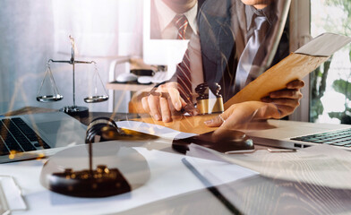 Business and lawyers discussing contract papers with brass scale on desk in office. Law, legal services, advice, justice and law concept picture with film grain effect