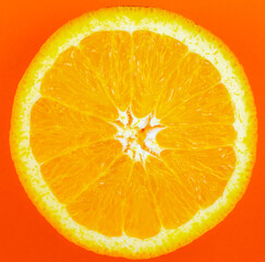 Orange fruit on orange background.  Minimalism, original beautiful photo.Beautiful nature wallpaper.