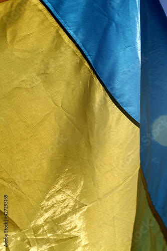 Ukrainian flag in sunbeams, vertical frame