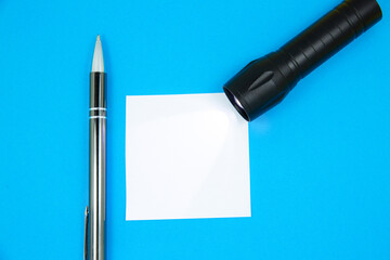 Blank white To Do List Sticker with flashlight and pen. Searching information on the Internet....