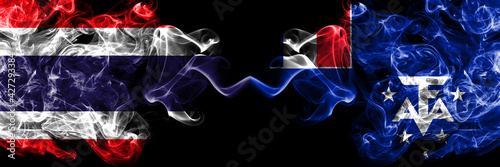 Thailand, Thai vs France, French Southern and Antarctic Lands smoky mystic flags placed side by side. Thick colored silky abstract smokes flags.