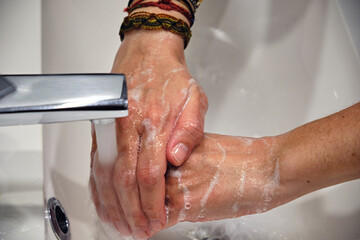 Wash hands by rubbing with soap for prevention of corona virus, hygiene to stop spreading coronavirus.