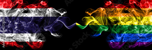 Thailand, Thai vs Gay, Pride smoky mystic flags placed side by side. Thick colored silky abstract smokes flags.