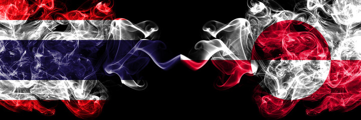 Thailand, Thai vs Greenland, Denmark, Danish smoky mystic flags placed side by side. Thick colored silky abstract smokes flags.