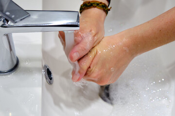 Fototapeta premium Wash hands by rubbing with soap for prevention of corona virus, hygiene to stop spreading coronavirus.