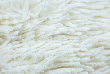 White cotton towel or carpet.fluffy texture background. Close up, macro photo. Soft focus image.