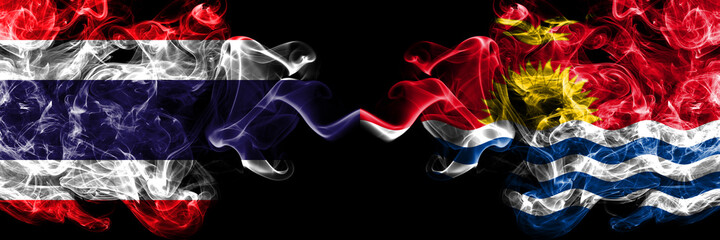 Thailand, Thai vs Kiribati smoky mystic flags placed side by side. Thick colored silky abstract smokes flags.