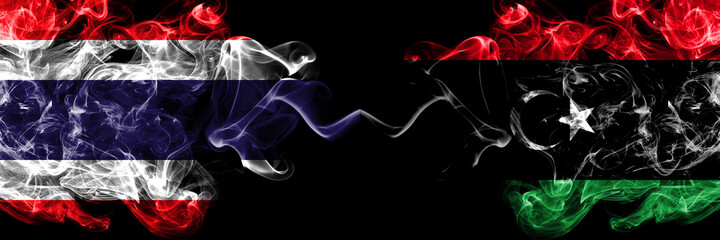 Thailand, Thai vs Libya, Libyan smoky mystic flags placed side by side. Thick colored silky abstract smokes flags.
