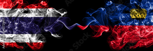 Thailand, Thai vs Liechtenstein smoky mystic flags placed side by side. Thick colored silky abstract smokes flags.