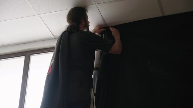 Person on production set cover window light with black fill 4K
