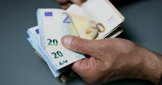 Manual counting of euro banknotes. Cash, 50 euro bills and 20 euro bills.