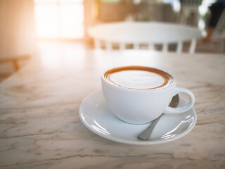 Side top view of hot coffee Cappuccino, espresso in the white cup put on the marble table in cafe morning work day background.