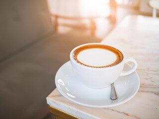 Side top view of hot coffee Cappuccino, espresso in the white cup put on the marble table in cafe morning work day background.