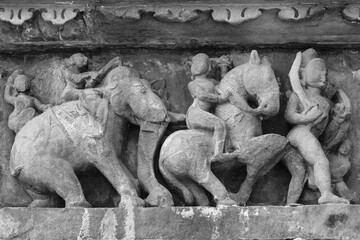 Stone carved erotic bas-relief in Hindu temple in Khajuraho, India.