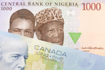 A macro image of a blue, purple and green one thousand  naira note from Nigeria paired up with a blue five dollar bill from Canada.  Shot close up in macro.