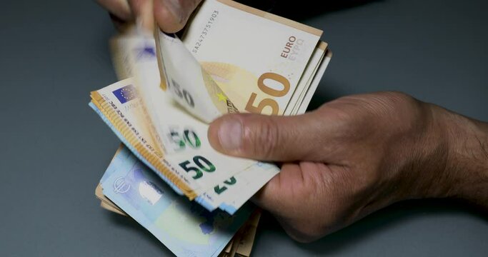 Manual counting of euro banknotes. Cash, 50 euro bills and 20 euro bills.