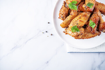 Spicy baked wings in a plate