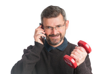 Naklejka premium Adult man with mobile phone and dumbbell isolated on white background